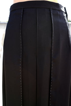 Amelia Classic Midi Skirt in black with pleated design and contrast hand stitch details.