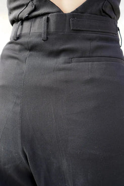 Close-up of the asymmetrical waist detail on Winnie Witt's black tapered pants