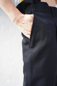 Detailed view of the pleated and tapered design in Winnie Witt's cropped pants