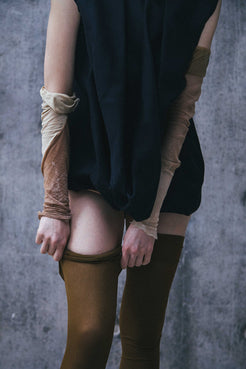 Model wearing Winnie Witt's black Deconstructed Dress, featuring a distinctive cowl neckline and convertible calf sleeves.